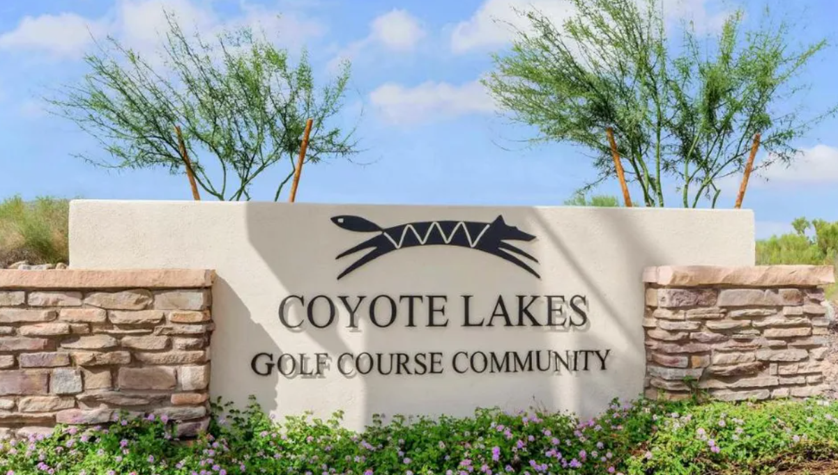 Coyote Lakes community entry sign with stone columns and desert landscaping in Surprise, Arizona